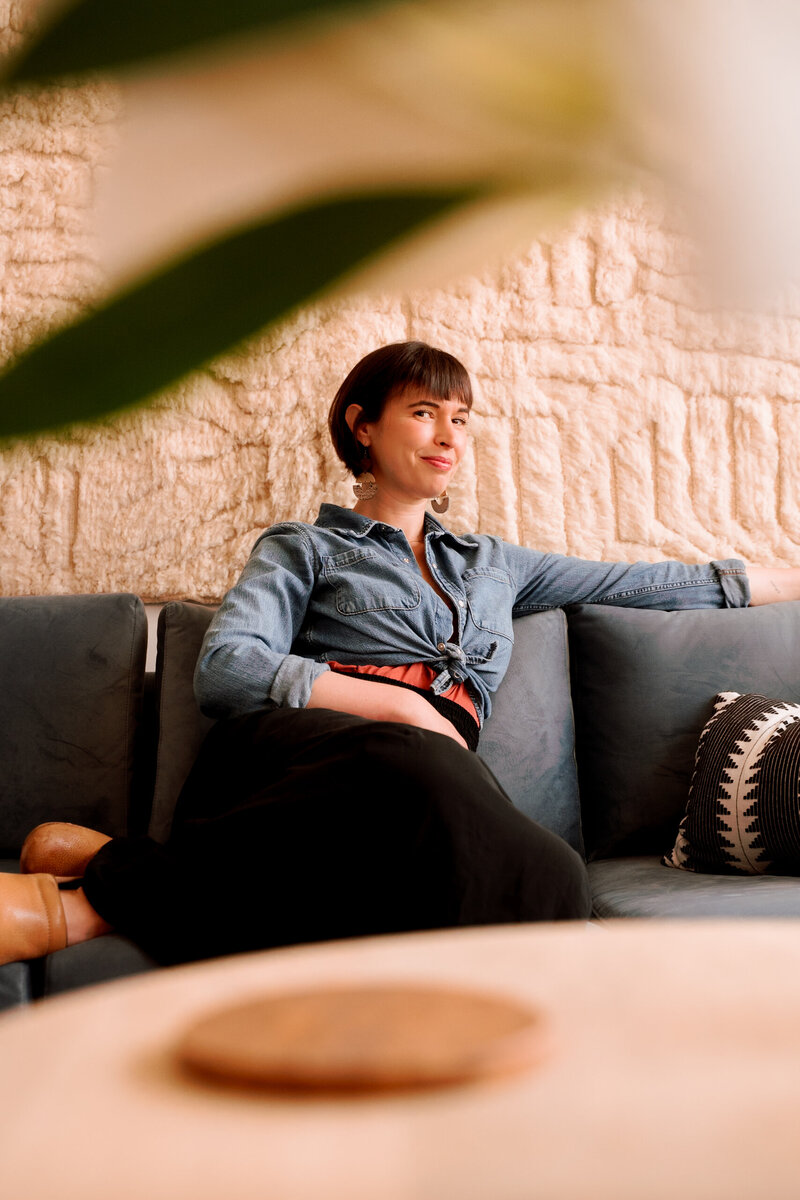 Sybil Ottenstein seated in the Brooklyn therapy office, offering somatic psychotherapy in a warm, grounded NYC setting.