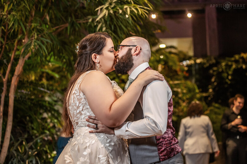 Couple kiss during their first dance inside Marnie's Pavilion at Denver Botanic Gardens