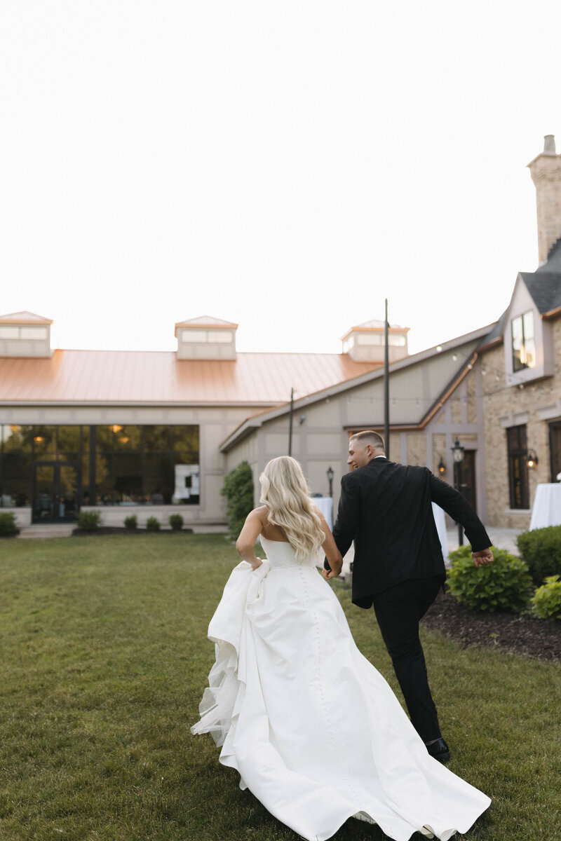 Bride and groom sunset running portrait
