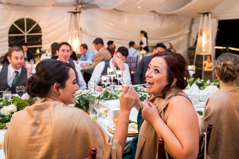 bridesmaids feed eachother dinner