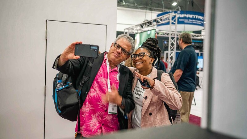 Alesia Hendley taking a selfie with a man on an event