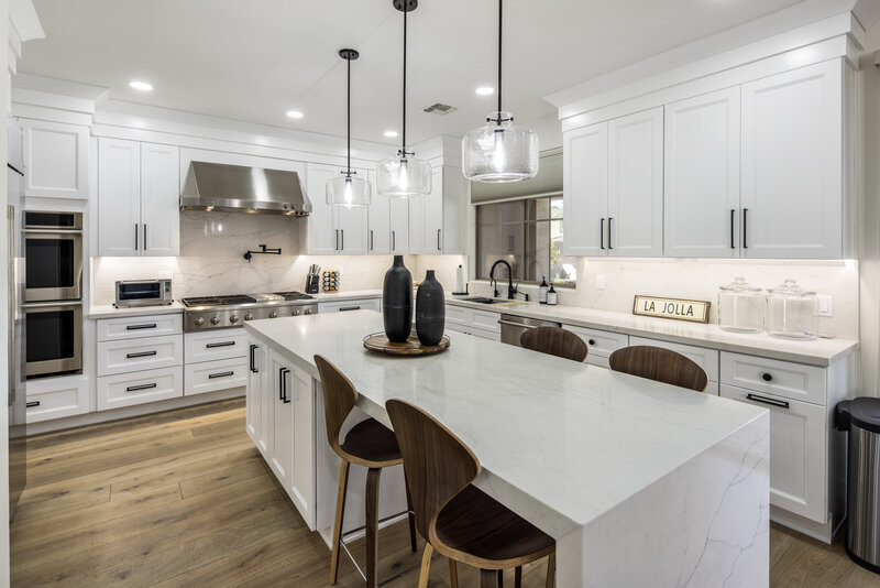 Phoenix Remodeled kitchen with engineered hardwood floors, white cabinets and marble countertops