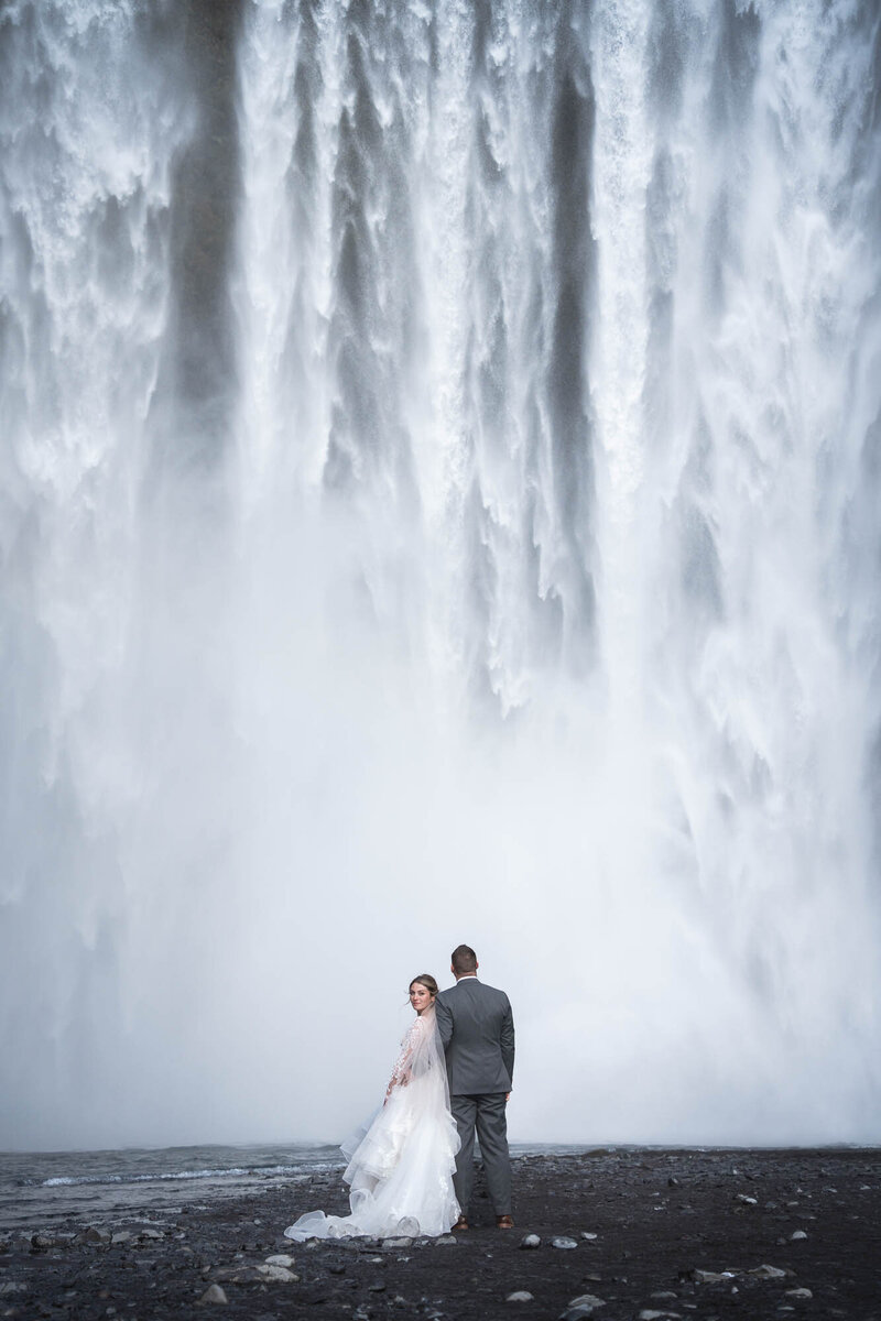 Elopement in front of Iceland's majestic Skogafoss waterfall.