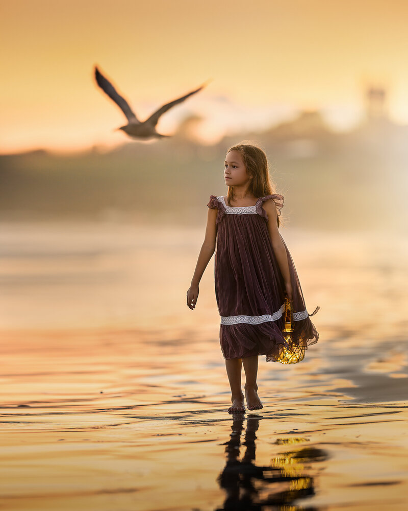A gorgeous sunset photo of a girl enjoying beautiful sunset at the beach by  Iya Estrellado Photography