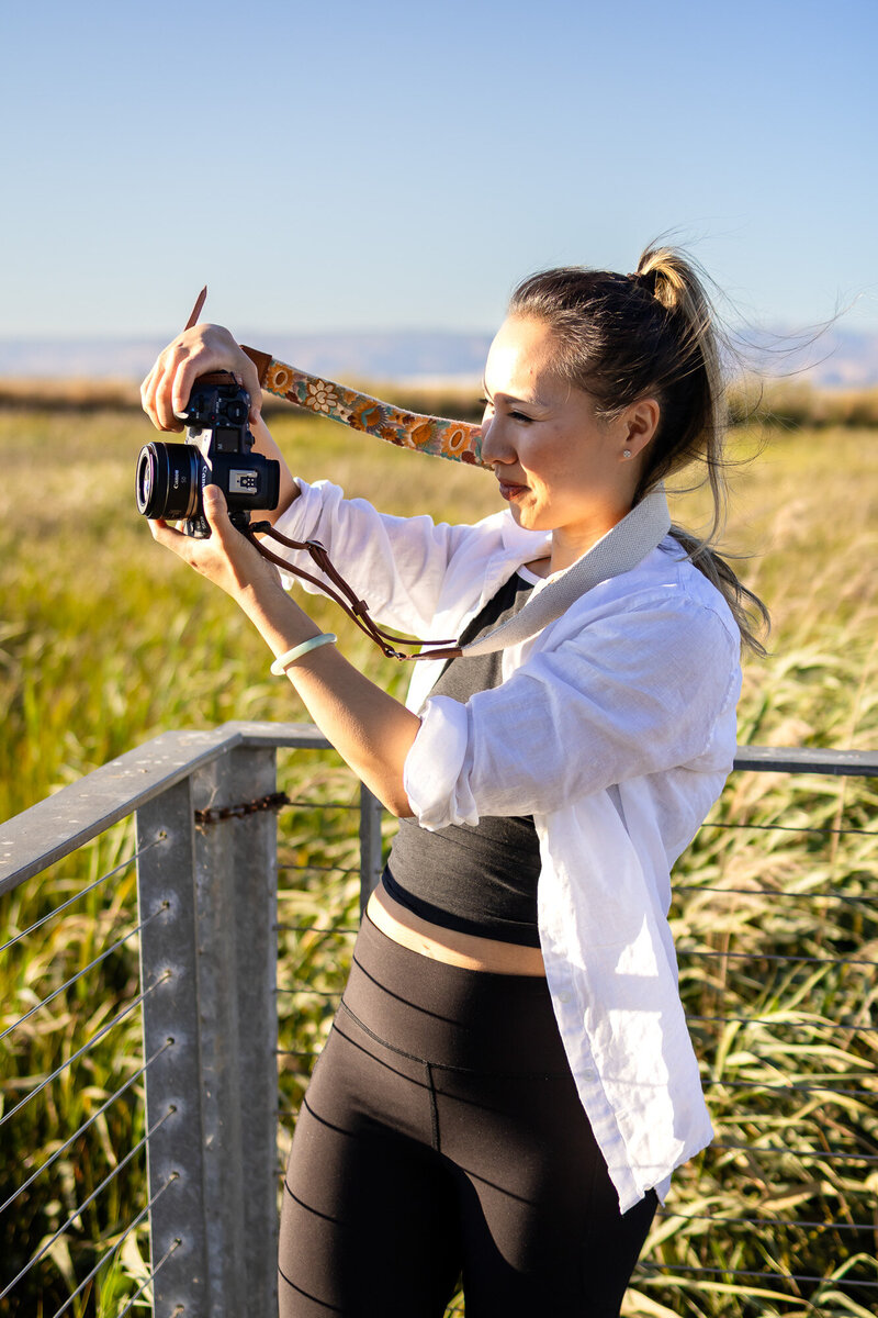 Bay Area Lifestyle Photographer - Ellobelle Photography Family Photographer smiles while photographing nature in warm golden sunlight
