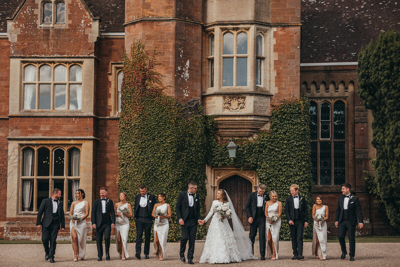 wedding party walk in front of venue