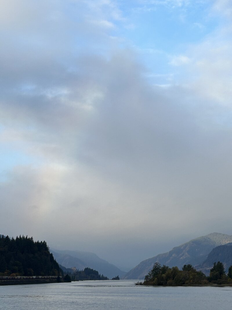 rainbow over lake and mountains in Portland, image taken by Caroline Amelie
