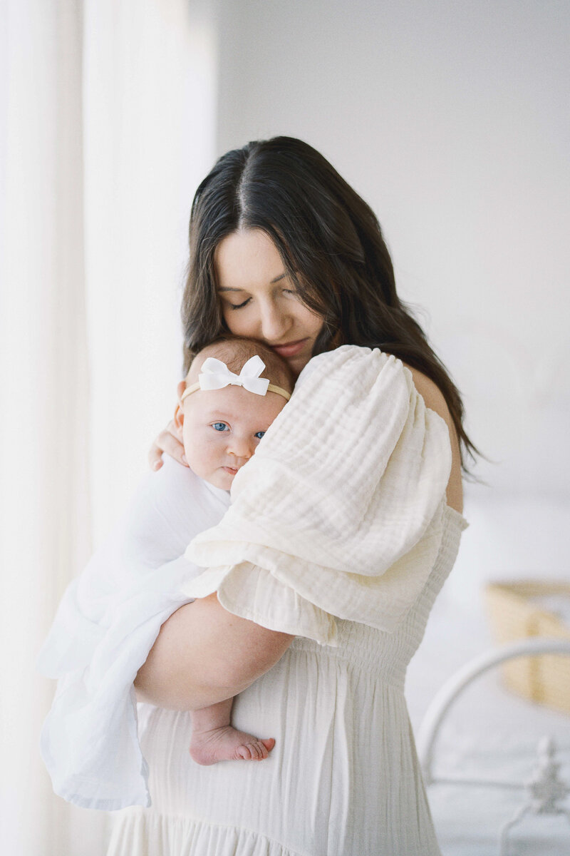 mom snuggling baby