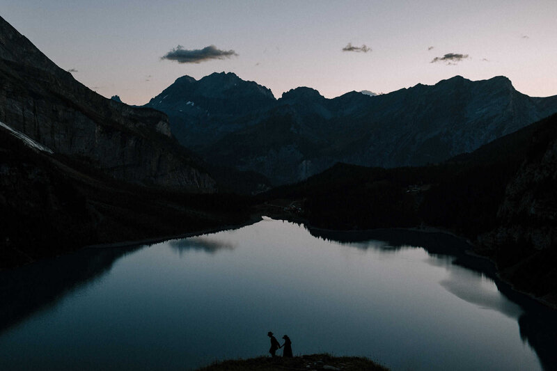 A couple embracing in front of a beautiful lake in Italy