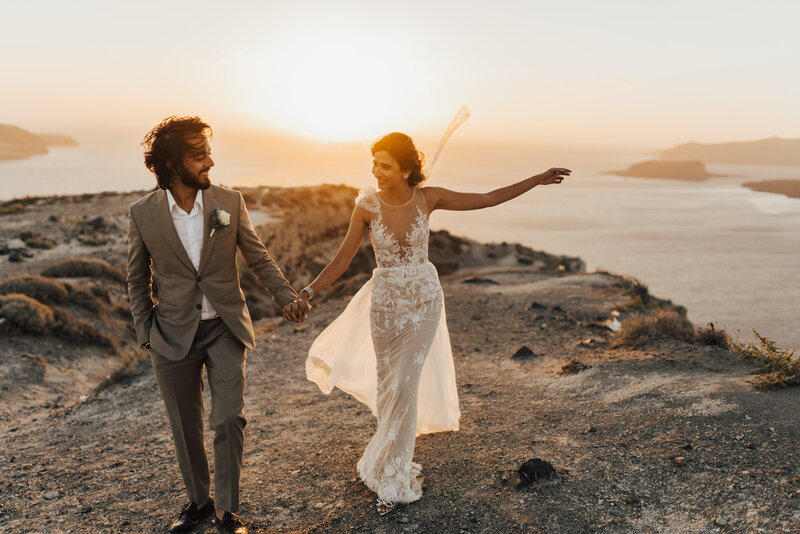 bride and groom walking on rocks