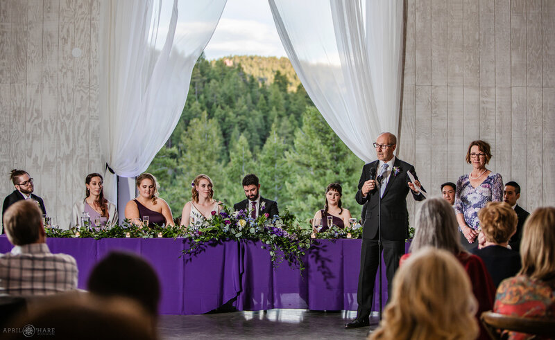 Wedding Toasts inside The Woodlands Barn wedding reception in Colorado Mountains