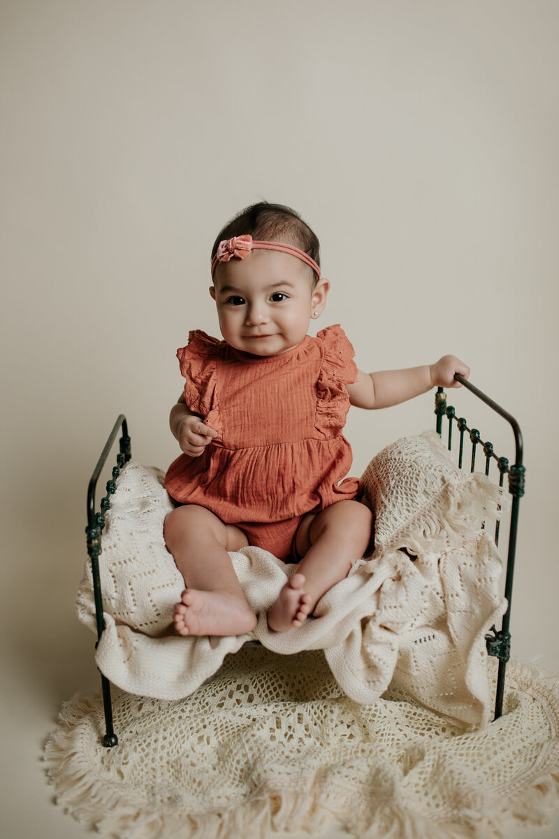 6 month old baby sitting up during her photography session in my Tucson photography studio