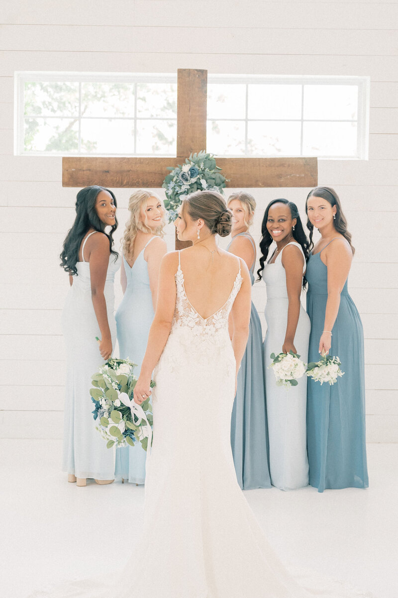 Fort Worth Wedding Photographer | DFW Photographer Rae De Lain Weddings Light and Airy | Groom embraces bride from behind while they sit on stairs