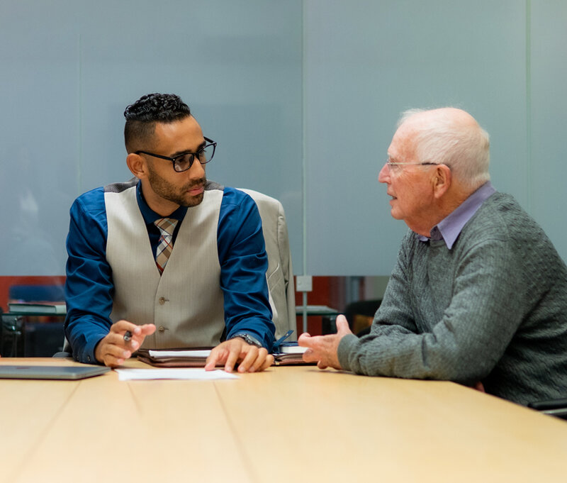 Columbus Ohio family law attorney listening to a male client at a desk during a consultation about domestic violence and civil protection orders