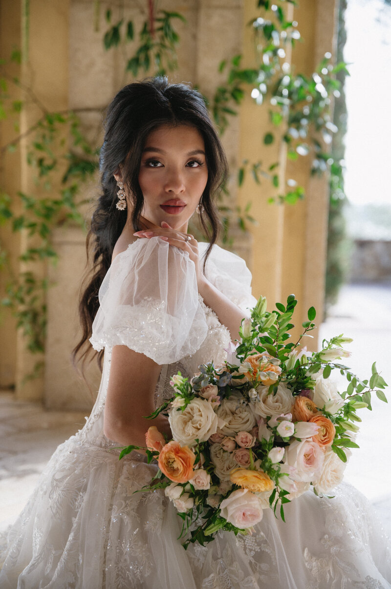 Bridal portrait of bride kneeling with bouquet