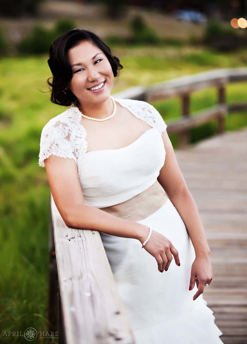 A stunning classic bridal portrait for a pretty Asian bride  on her wedding day at Evergreen lake House in Colorado
