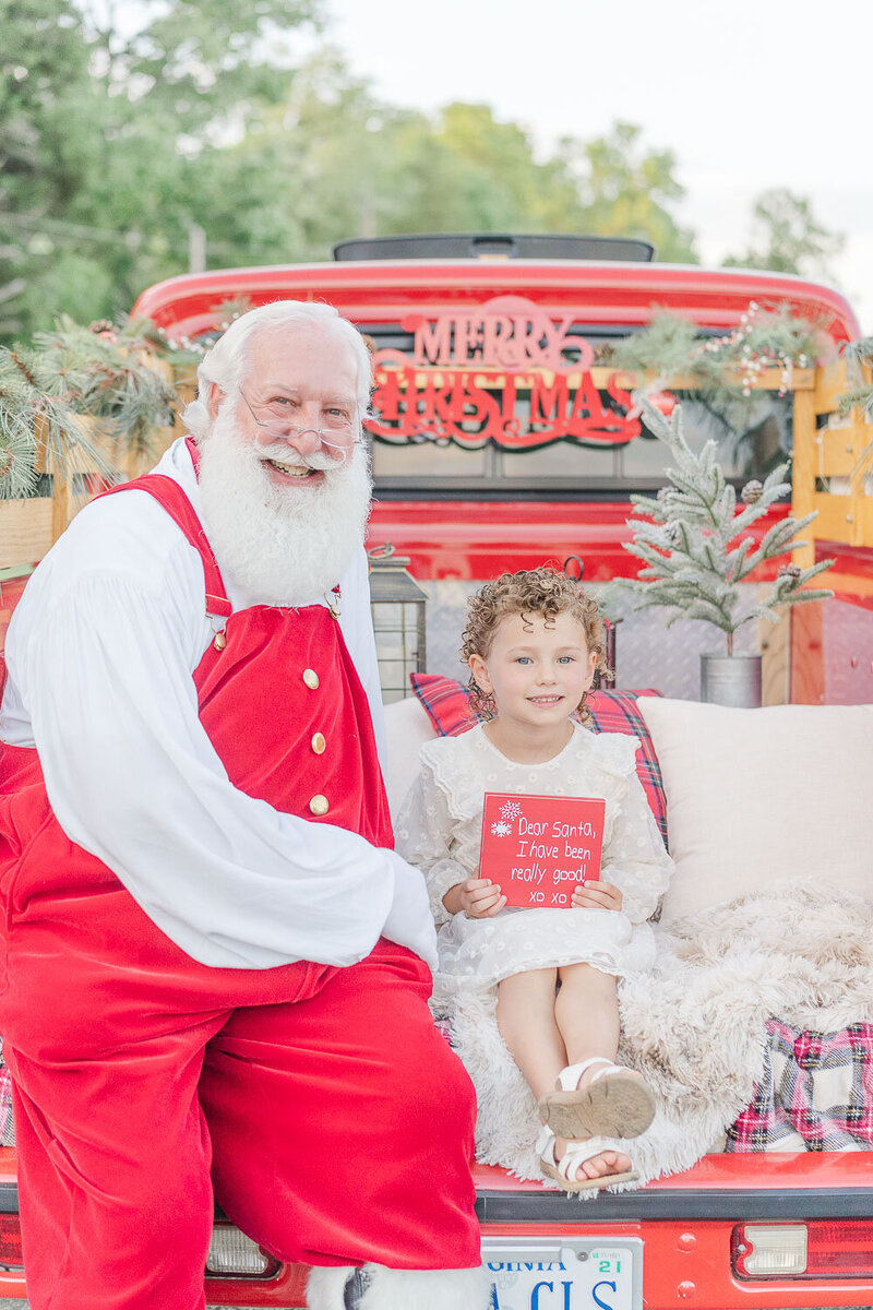kid and Santa posing for photos during red truck minis in Prince William County, VA