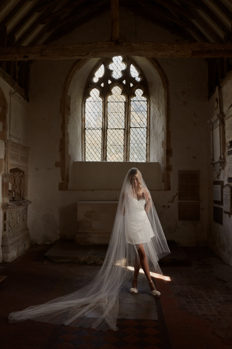 Handmade mini silk wedding dress, corset-style, short dress worn by bride in chapel