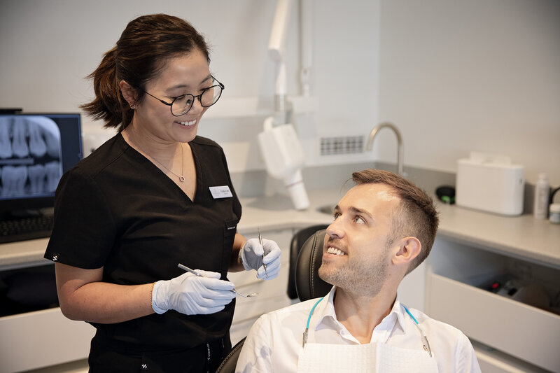 dentist cleaning patient's teeth