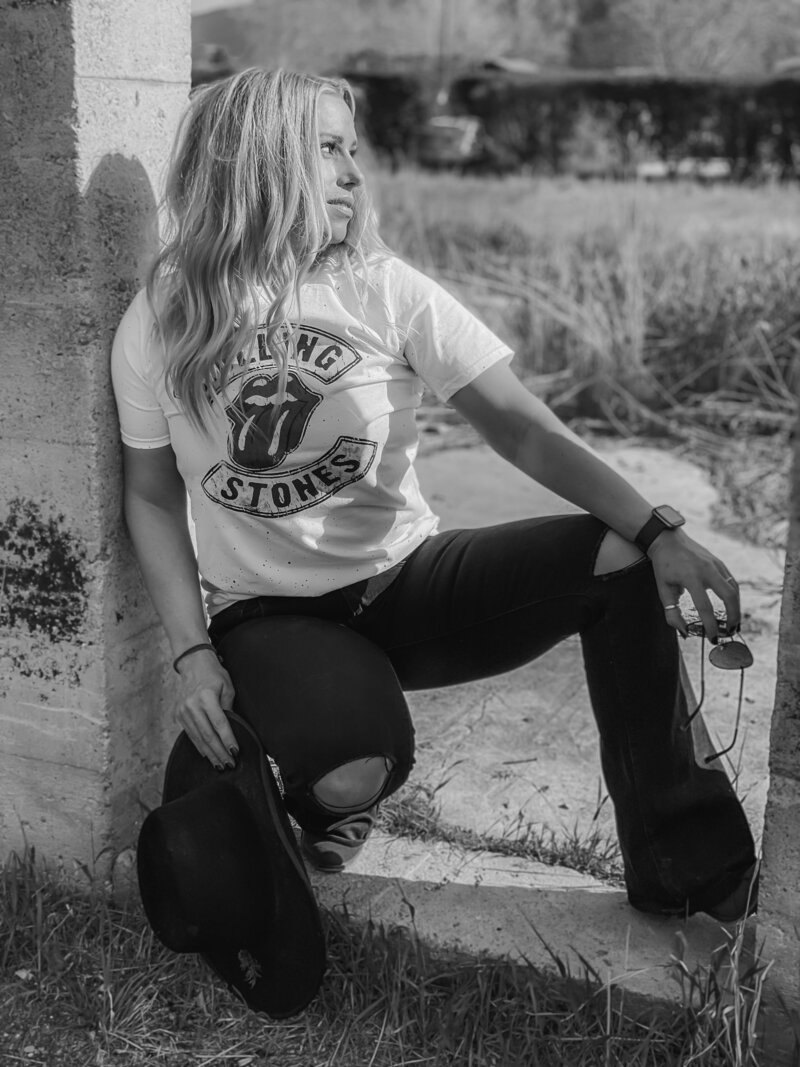 Brittney-Long-In-RollingStonesGraphicTshirtAndRippedBlackFlaredJeans