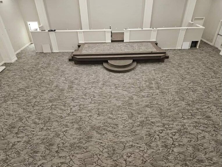 Finished commercial carpet project with light gray carpets.