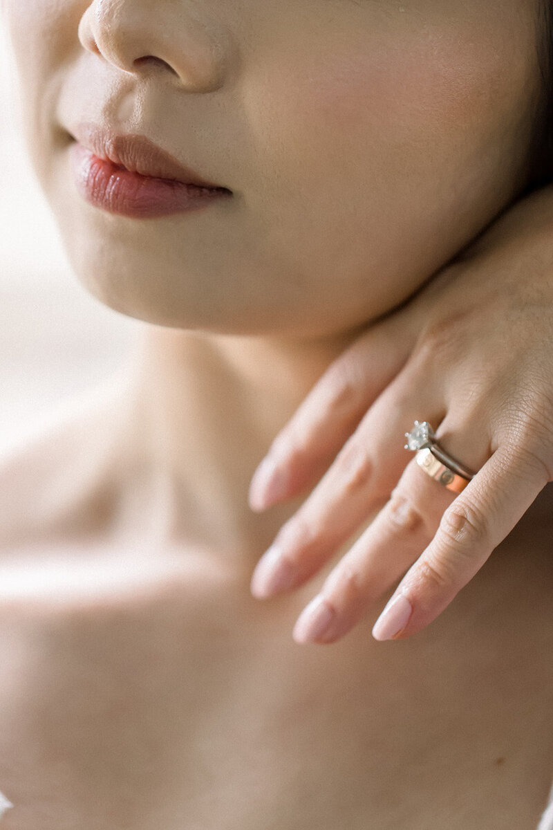 bride's lips, lower half of face, and hand with wedding ring