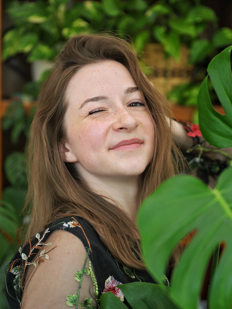 me in a floral dress surrounded by plants