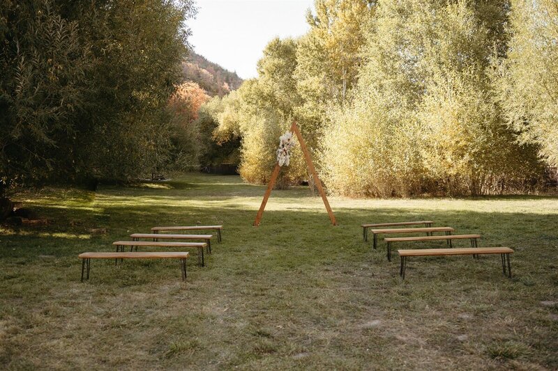 Ceremony location with an A frame style arch with minimalist styling.