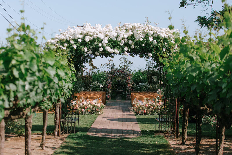 bride and groom hugging as she holds her purple flower bouquet