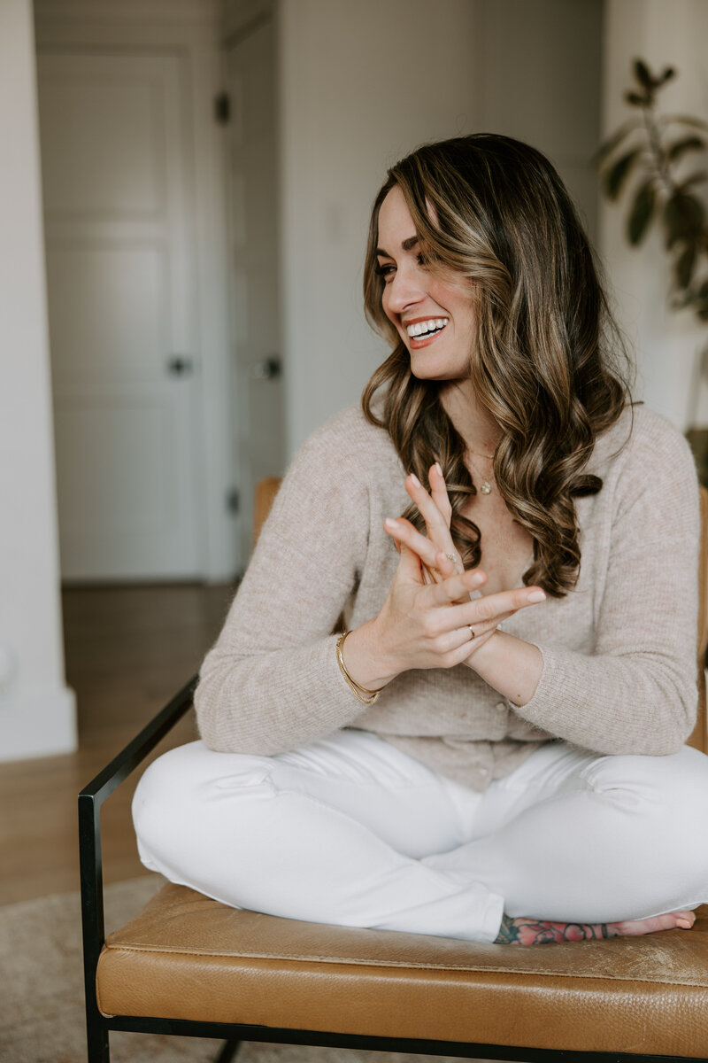 SEO website copywriter Erika Fitzgerald sitting on a leather chair