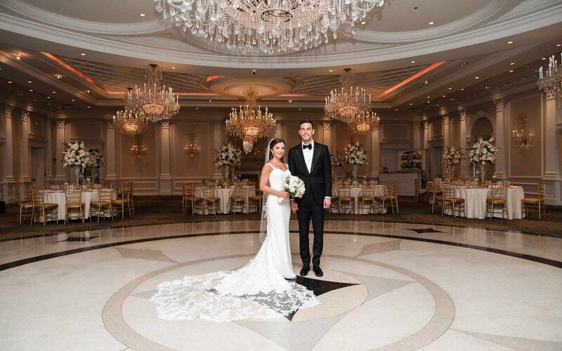Bride and groom posing inside the grand ballroom for Fort Myers wedding photographer