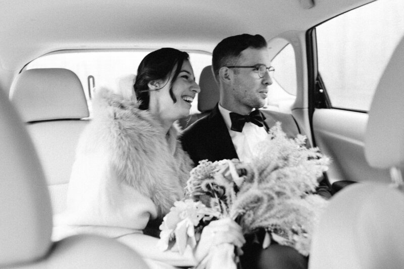 Bride and Groom in car laughing