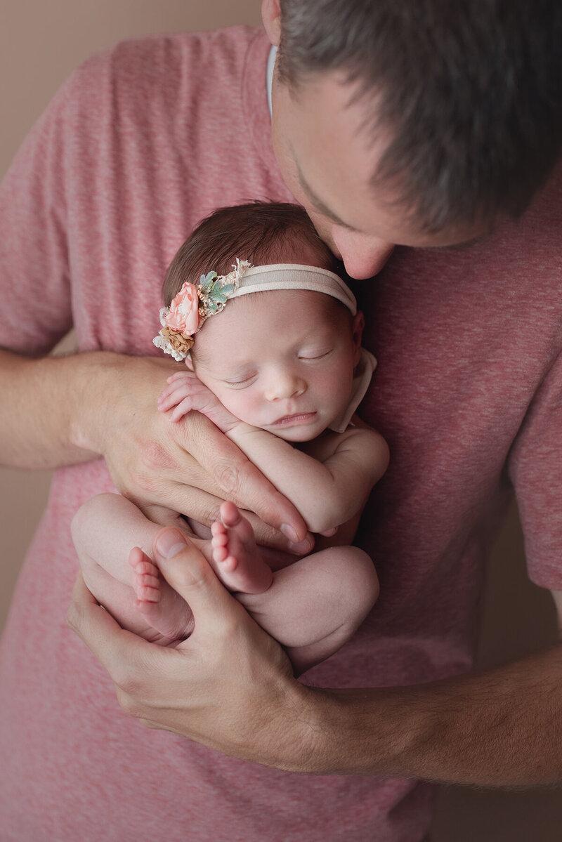 newborn baby girl held by her daddy