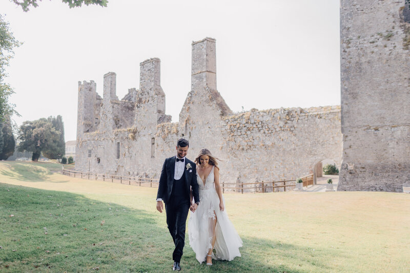 bride-and-groom-walking-in-formal-gardens-at-castlemartyr