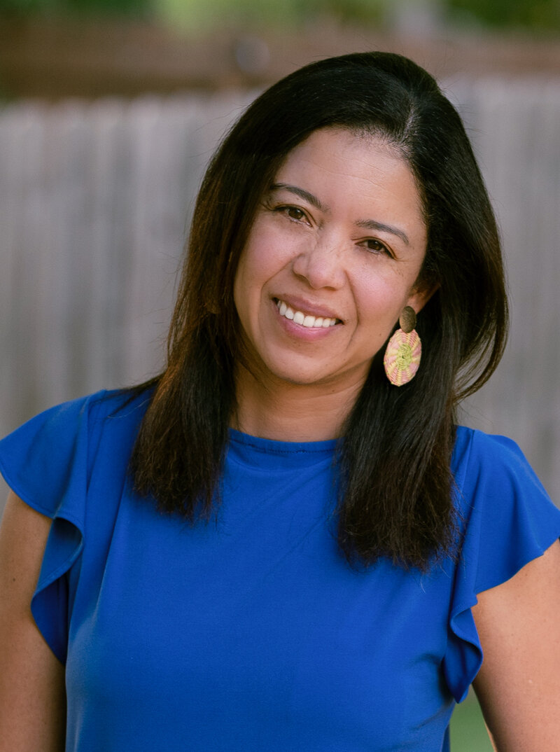 female looking at camera, arms crossing and smiling