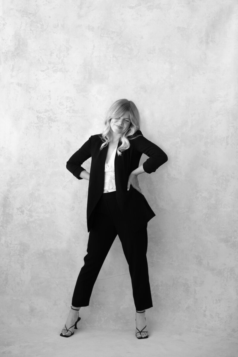 Female fine art photographer standing in black suit in Los Angeles