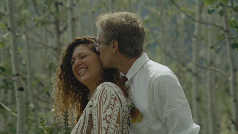 groom kissing bride's forehead