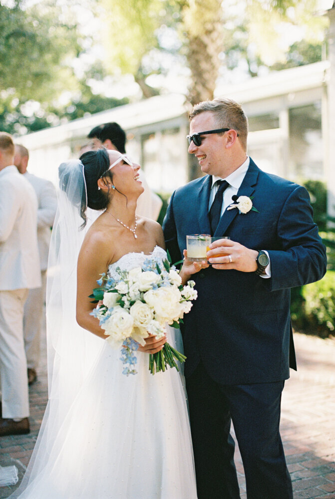 couple just married in charleston toasting their cocktail drinks