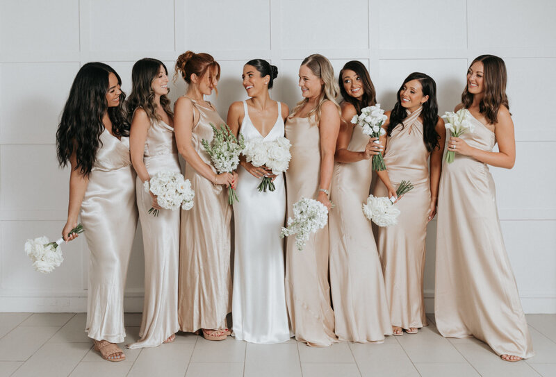 Bride with her bridesmaids smiling