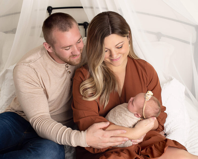 Cleveland, Akron and Canton Area Newborn Photographer. Lifestyle family newborn photo of Mom, Dad and Newborn.