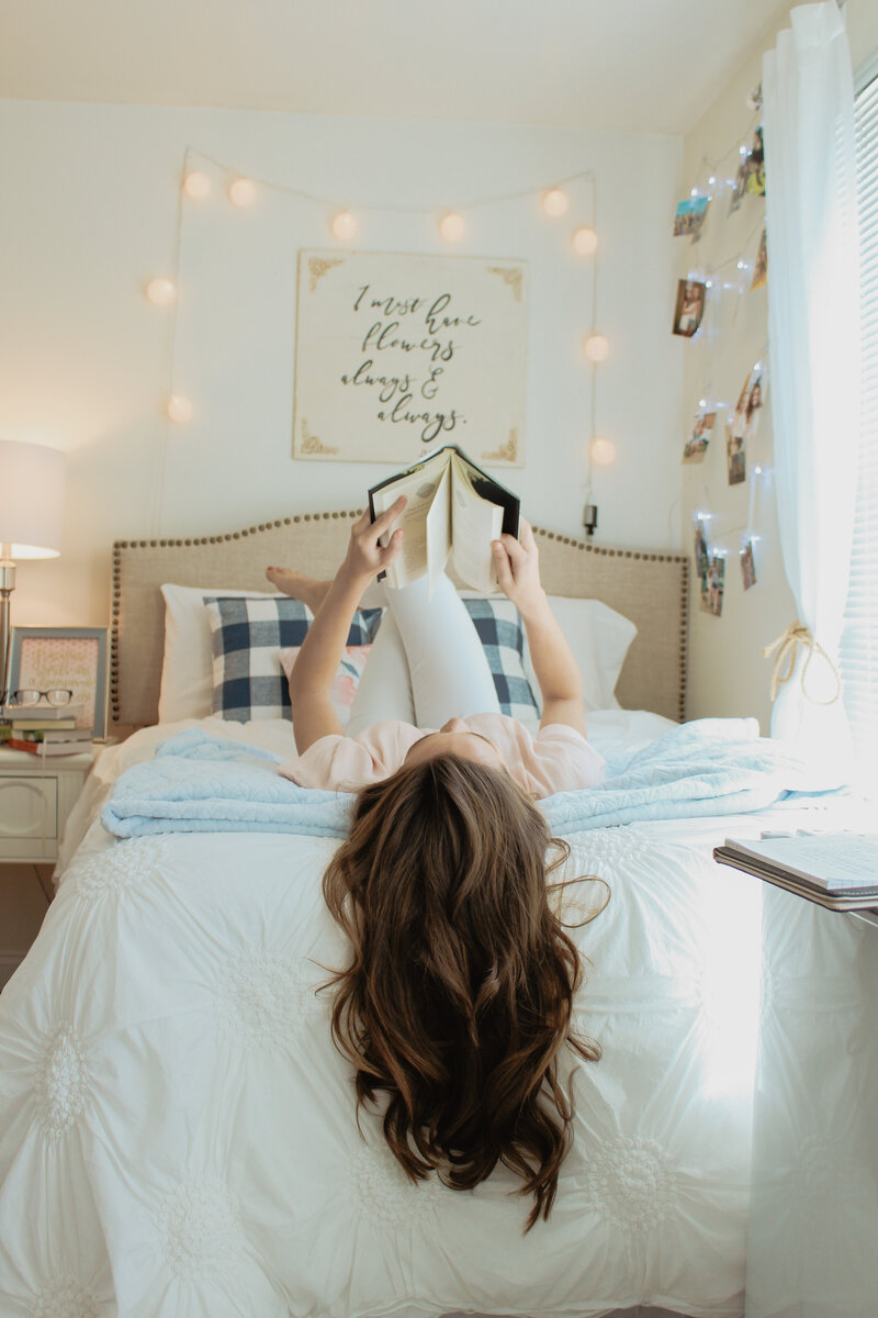 woman reading on her bed