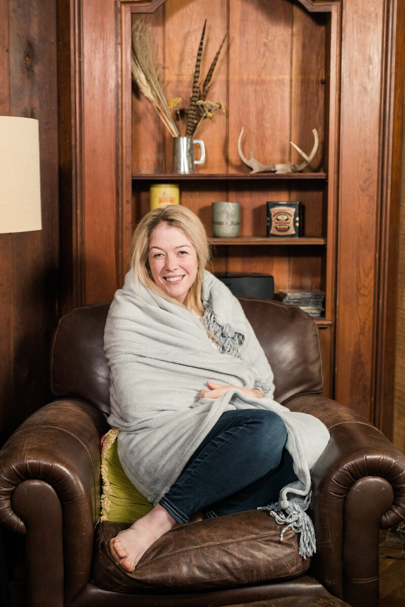 Amanda sitting on a chair in her cabin