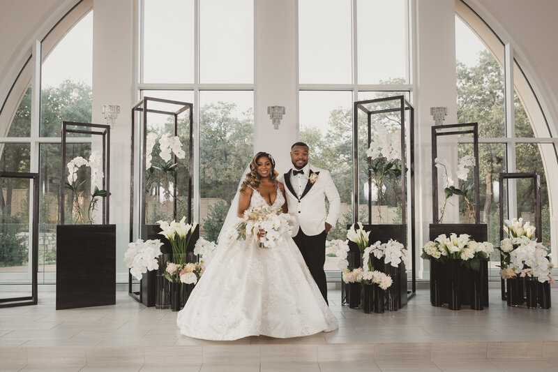 Swank Soiree Dallas Wedding Planner Jamie and Dwayne at The Bowden Wedding Venue - Bride and Groom in front of white orchids