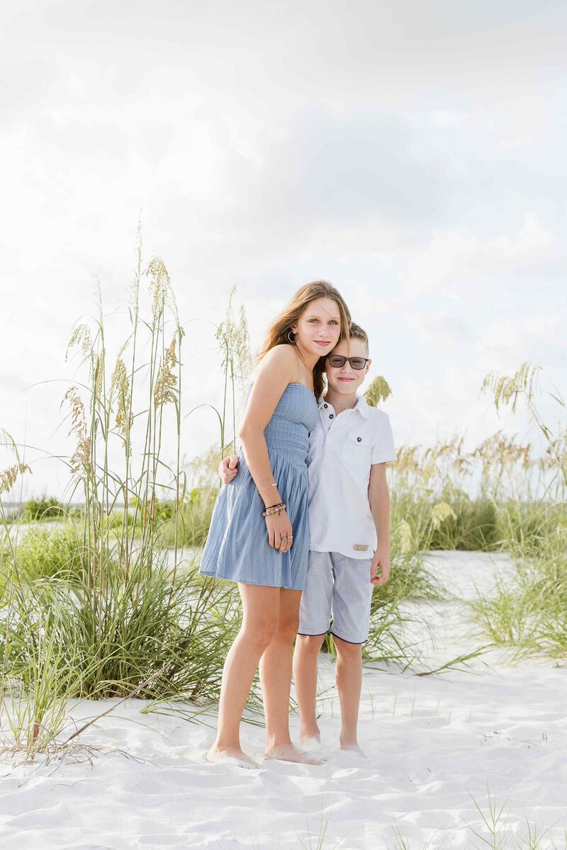 Brother and sister hugging on Fort Myers Beach