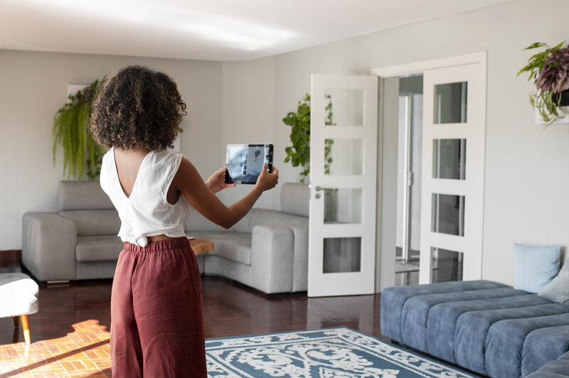 Woman taking a photo of her cozy apartment