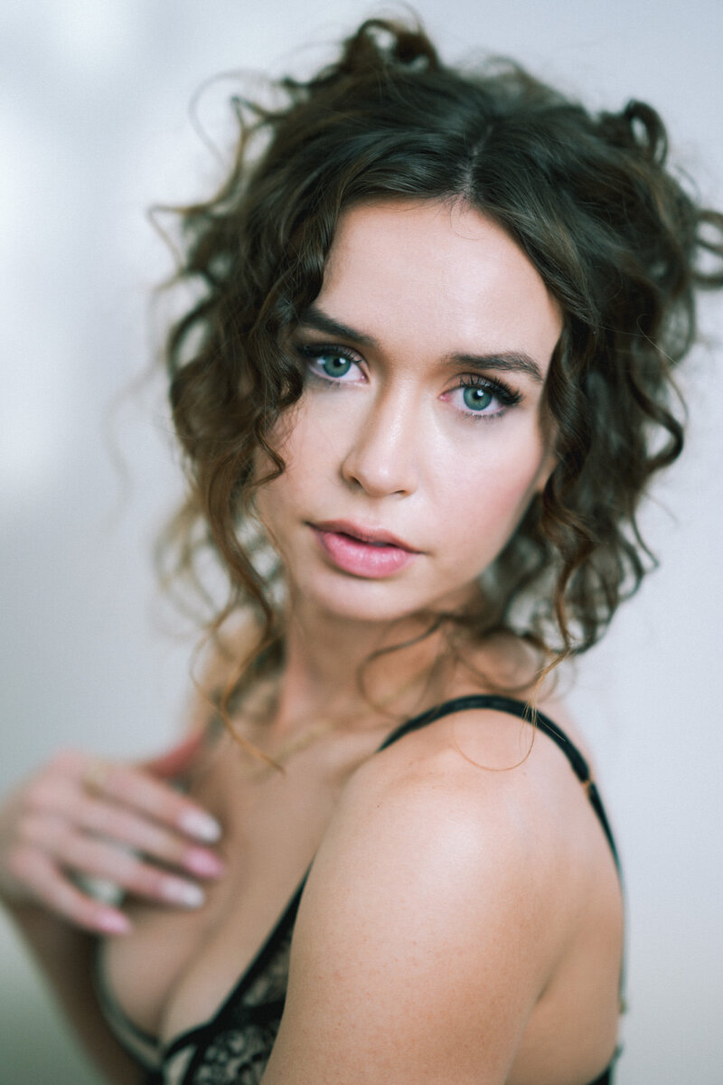 Close up portrait of boudoir client with curly hair