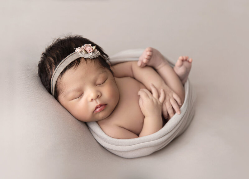 Newborn baby girl with bow