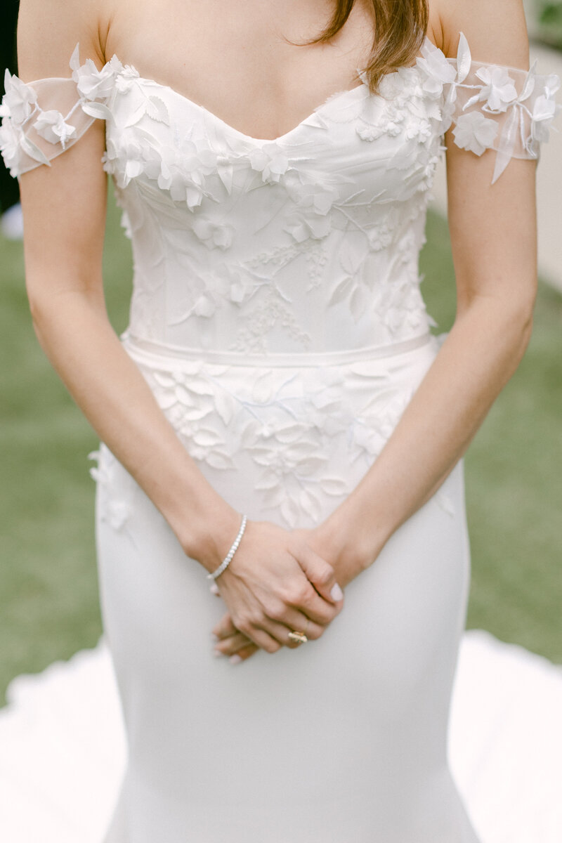 Close up of intricate detailing on bride's wedding gown