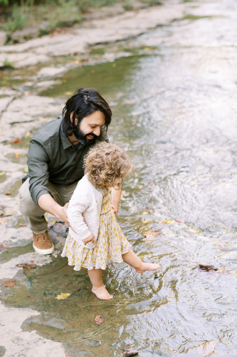 Little girl standing near the river with father in Nashville TN