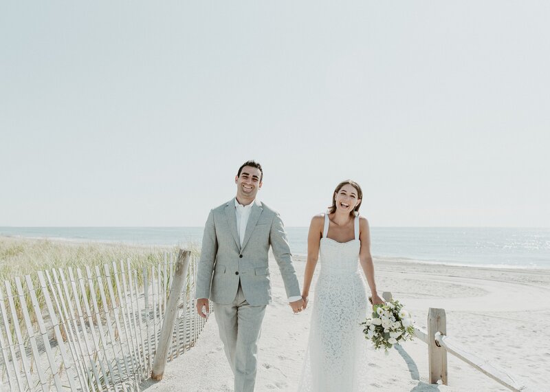 bride and groom walking on beach at their summer wedding in Laguna Beach